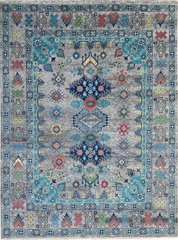 Distressed gray rug featuring a bright tribal medallion design and multiple borders in teal and navy blue.