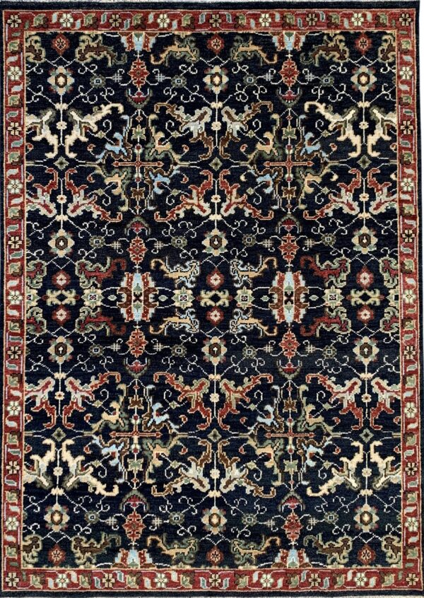 Dark blue traditional low-pile rug with intricate multicolored patterns and a prominent red floral border.