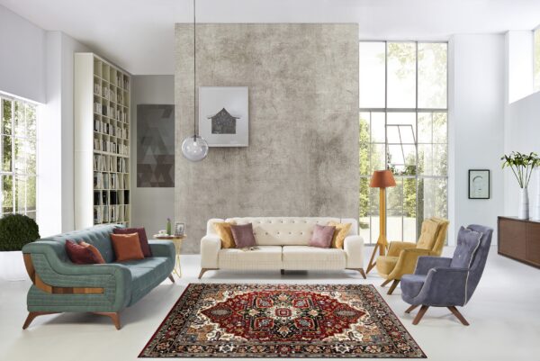 A detailed traditional red rug defines a living area with a textured grey wall and brightly lit windows.