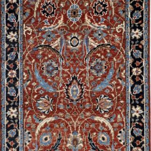 Traditional rust-red rug featuring complex blue and beige floral patterns and a wide navy border.