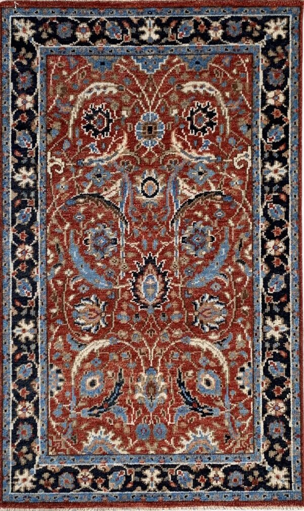 Traditional rust-red rug featuring complex blue and beige floral patterns and a wide navy border.