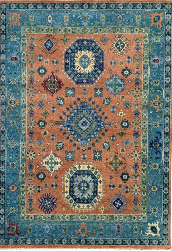 Traditional blue and teal border surrounds a rust field densely patterned with scattered geometric motifs.