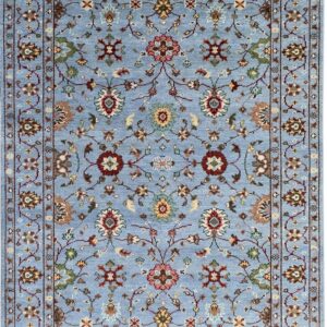 Traditional light blue rug with an all-over intricate floral design in maroon, tan, green, and pink.