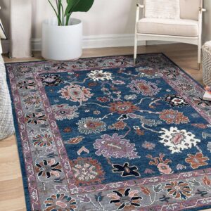 Blue traditional rug featuring gray and purple borders and multi-colored floral patterns on wood floor.