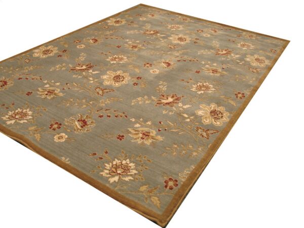 Slate blue rug featuring an all-over floral pattern in gold and rust with a thick brown border.