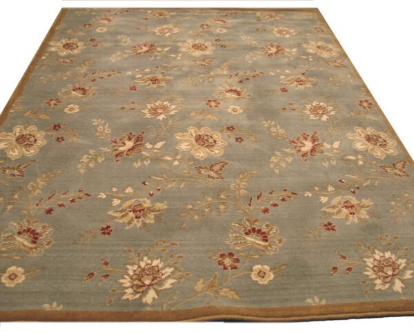 Dusty sage area rug with trailing beige and reddish floral vine patterns and a contrasting brown border.