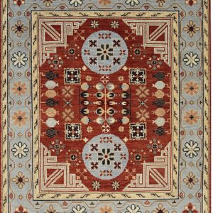 Rust-colored rug with geometric medallions and wide borders in pale blue and cream.