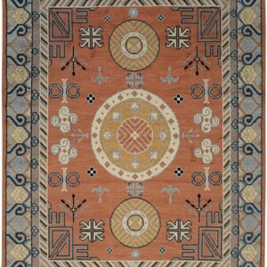 Rust orange rug with gold, gray, and dark blue geometric tribal symbols and medallions.