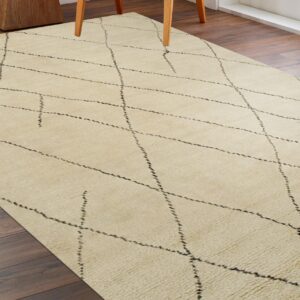 High-pile cream rug with a dashed black diamond pattern on dark wood plank flooring.