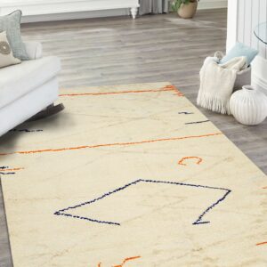 Textured cream rug with sparse abstract navy and orange patterns on light gray wood flooring.