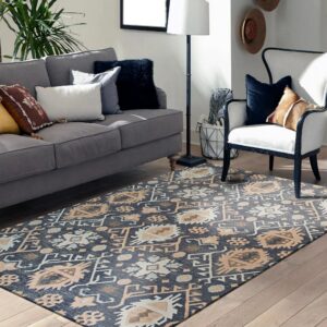 Navy and tan tribal rug anchors a living room with a gray sofa, white armchair, and wood floor.