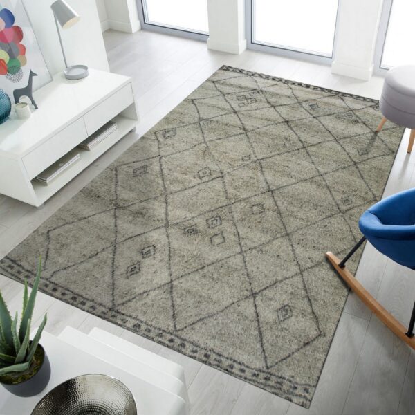 A light grey high pile rug featuring a dark diamond pattern in a bright, modern living room.