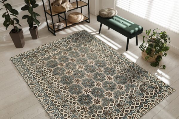 Teal and brown geometric tile rug on light wood floors next to a green velvet bench.