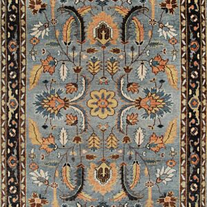 Geometric high-pile rug displaying stepped medallions in gray, blue, brown, and cream squares.