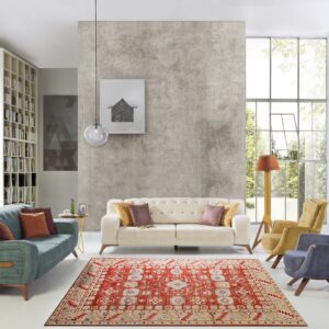 Vibrant red, cream, and blue patterned rug defines a modern living area with white and gray walls.