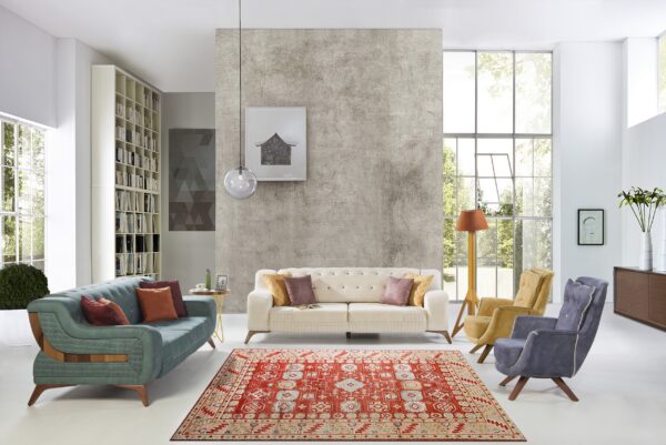 Vibrant red, cream, and blue patterned rug defines a modern living area with white and gray walls.