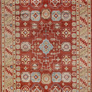 Rust red rug featuring geometric designs in beige, light blue, and tan with thick patterned borders.