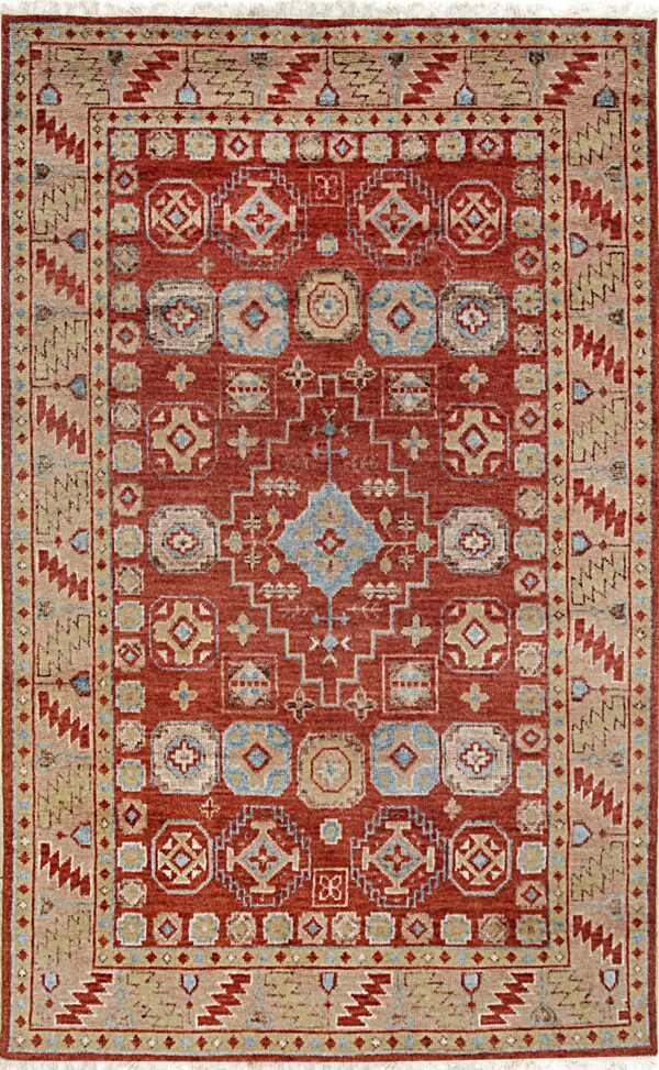 Rust red rug featuring geometric designs in beige, light blue, and tan with thick patterned borders.