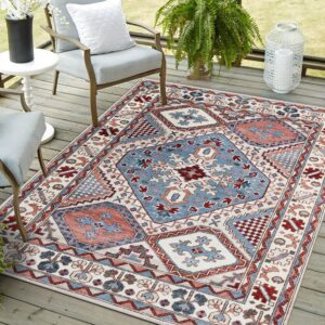 Blue, rust, and off-white geometric rug placed on a wooden deck with outdoor furniture and plants.
