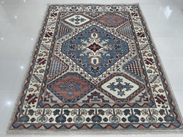 A blue, rust, and cream geometric patterned area rug resting on shiny white floor tiles.