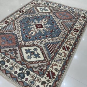 The geometric rug features slate blue, cream, and maroon colors over a reflective white tile floor.