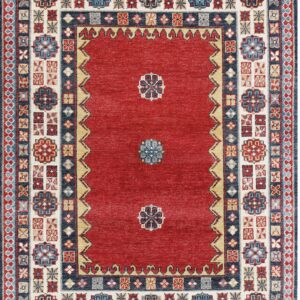 Red rug featuring a minimal center design and complex geometric borders in navy, cream, and blue.