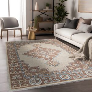 Geometric cream rug with rust and blue accents anchors a living area with a white sofa and dark wood floor.