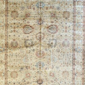 Shimmering beige rug with complex traditional medallions and borders in subtle blue and terracotta tones.