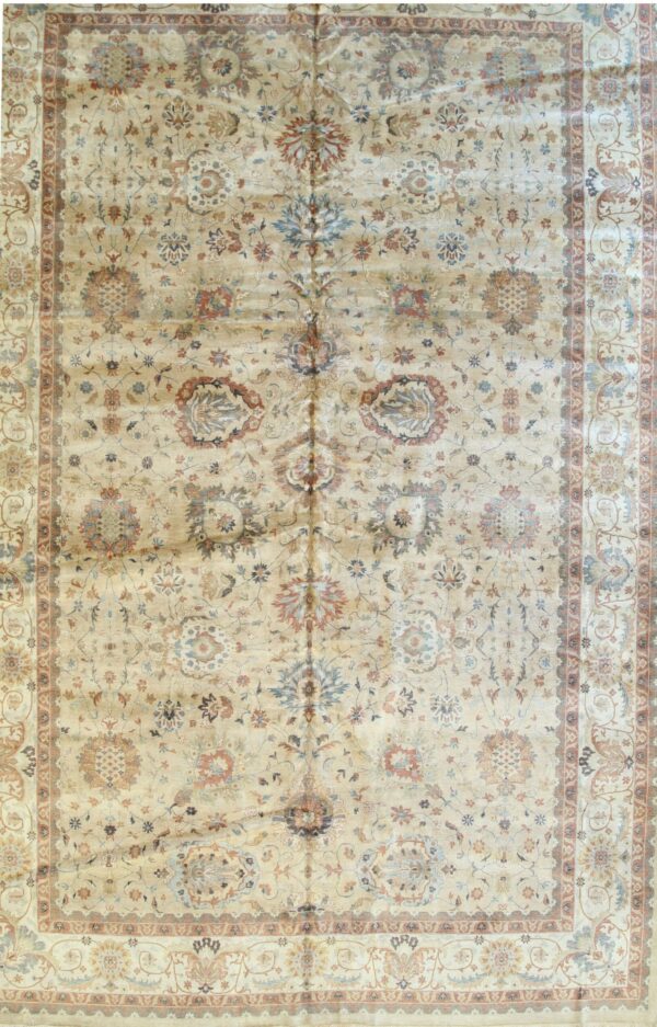Shimmering beige rug with complex traditional medallions and borders in subtle blue and terracotta tones.