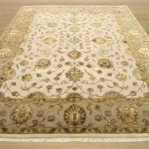 Ornate cream area rug with detailed gold floral motifs and a contrasting sage green main border.