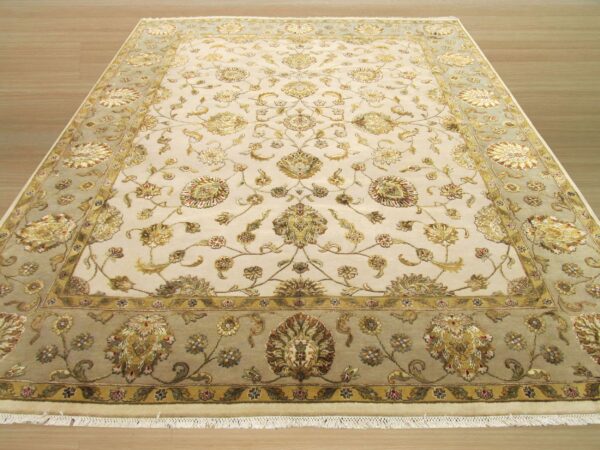 Ornate cream area rug with detailed gold floral motifs and a contrasting sage green main border.
