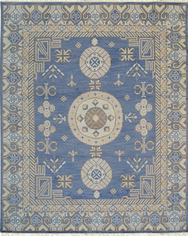 Blue rug featuring geometric medallions and intricate borders in beige, tan, and cream.