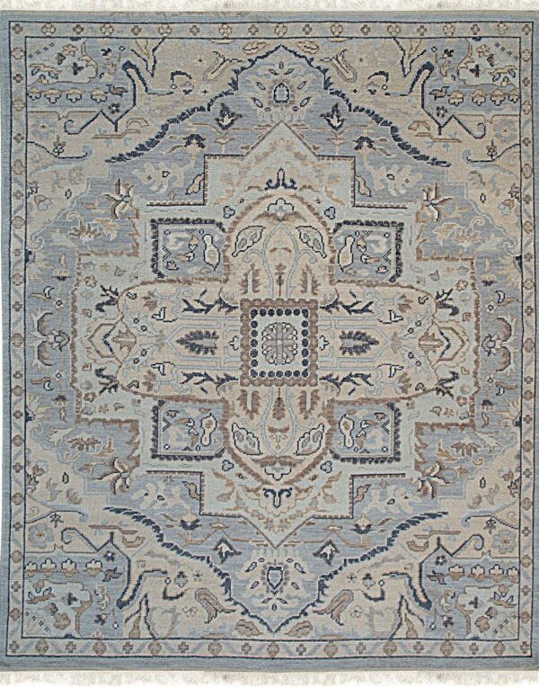 Traditional rug with central medallion, using slate blue, beige, and brown colors, finished with fringe.