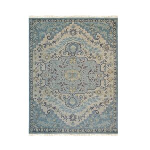 Traditional medallion rug in teal, beige, dark blue, and yellow with visible fringe tassels.