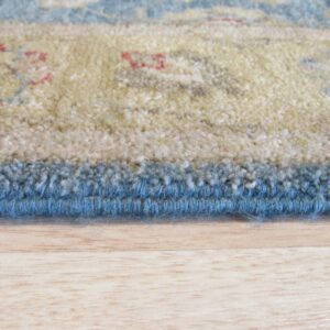 Thick pile rug with tan, blue, and red floral pattern rests on a blonde wood floor.
