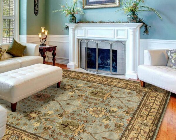 A patterned teal and tan rug grounds a formal living room with a white fireplace and sofa.
