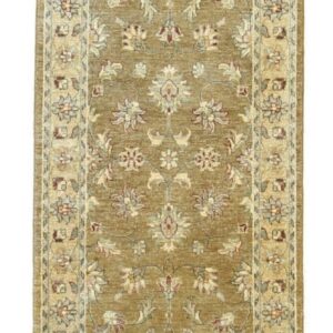 Traditional runner rug in warm olive and cream, featuring an intricate floral motif bordered by smaller patterns.