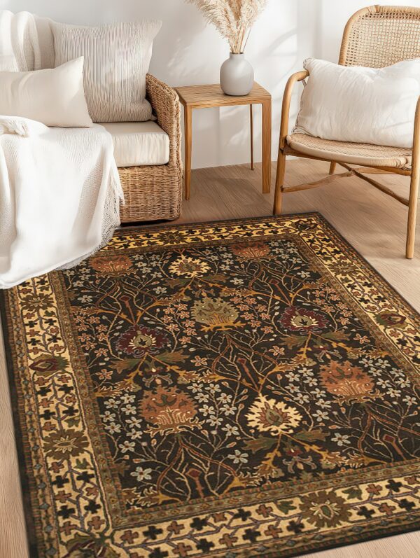 Dark brown floral rug with gold and rust accents laying on wood floor next to natural rattan furniture.