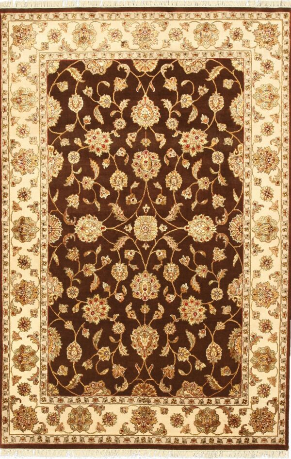 Brown and cream rug displaying an elaborate traditional floral vine pattern in the dark field and wide border.