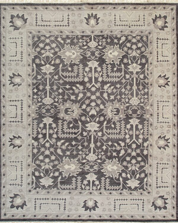 Intricate traditional rug with charcoal gray and light gray medallion and complex geometric border.