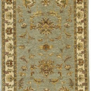 A sage green runner rug displays intricate gold and tan traditional floral designs and a wide cream border.