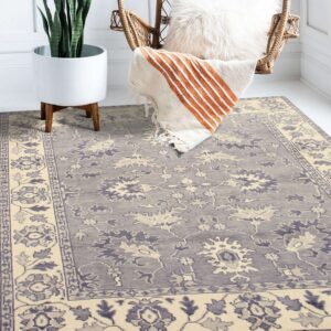 Traditional gray and cream low-pile rug beneath a wicker chair and a potted snake plant.