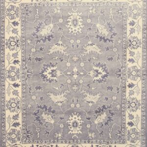 Traditional blue-grey rug with an ornate floral and medallion design set within cream borders.
