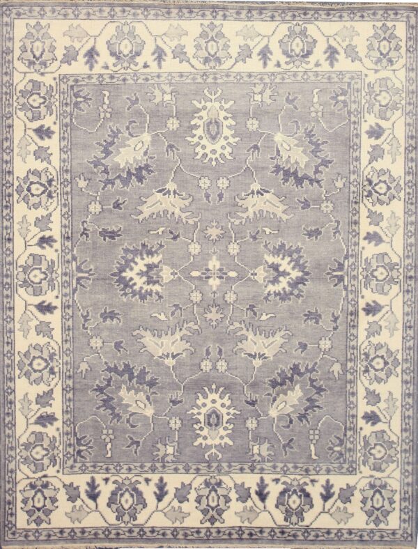 Traditional blue-grey rug with an ornate floral and medallion design set within cream borders.