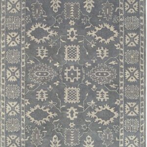 Slate blue rug with cream traditional geometric and stylized floral motifs and layered borders.