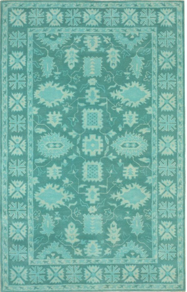 Traditional rug in varying shades of teal and aqua with large stylized floral motifs and geometric borders.