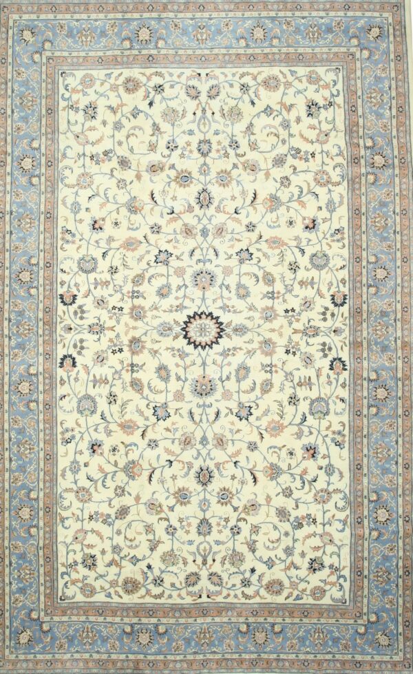 Traditional cream rug featuring detailed blue and peach floral motifs and a wide blue border.