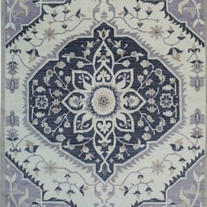 Low-pile rug displaying a traditional medallion pattern in navy, cream, and dusty lavender colors.
