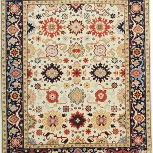 Ivory rug featuring repeating traditional medallions in red, navy, and gold, with a dark blue border.