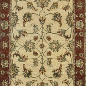 Beige runner rug with a repeating floral pattern in olive, brown, and set within red borders.